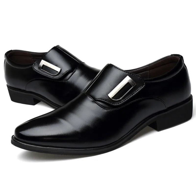 Black dress shoes with silver buckles on a white background
