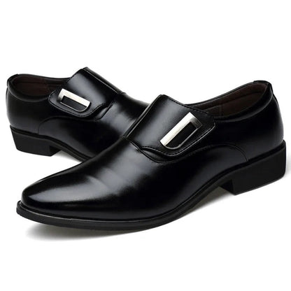 Black dress shoes with silver buckles on a white background