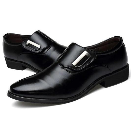 Black dress shoes with silver buckles on a white background
