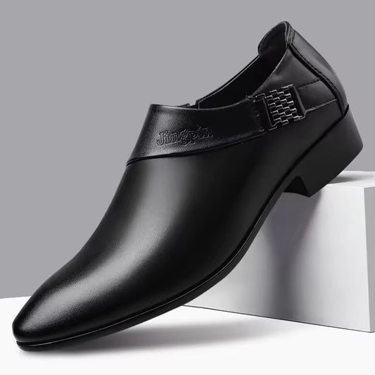 Black leather dress shoe with a brand logo on a gray background