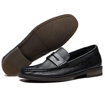 Black leather loafer shoes on a white background