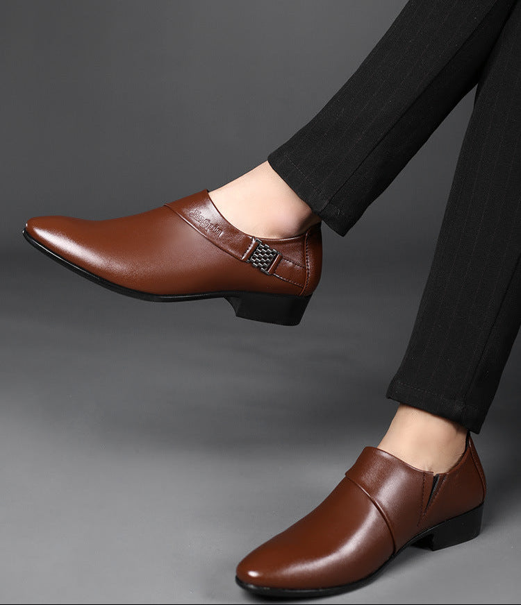 Brown leather shoes worn with black pants on a gray background