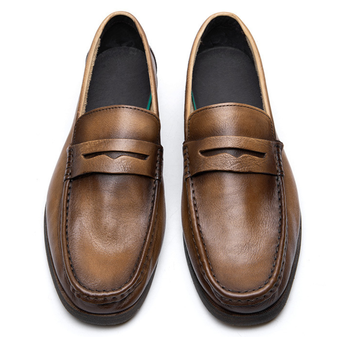 Pair of brown loafers on a white background
