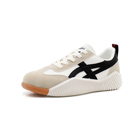 Sneaker with beige, black, and white design on a white background