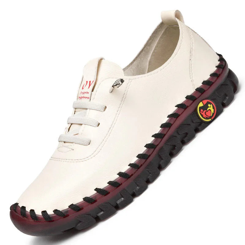 White sneaker with black sole and red and yellow logo on a white background