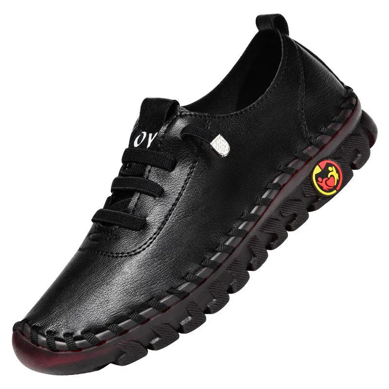 Black leather shoe with a red sole on a white background