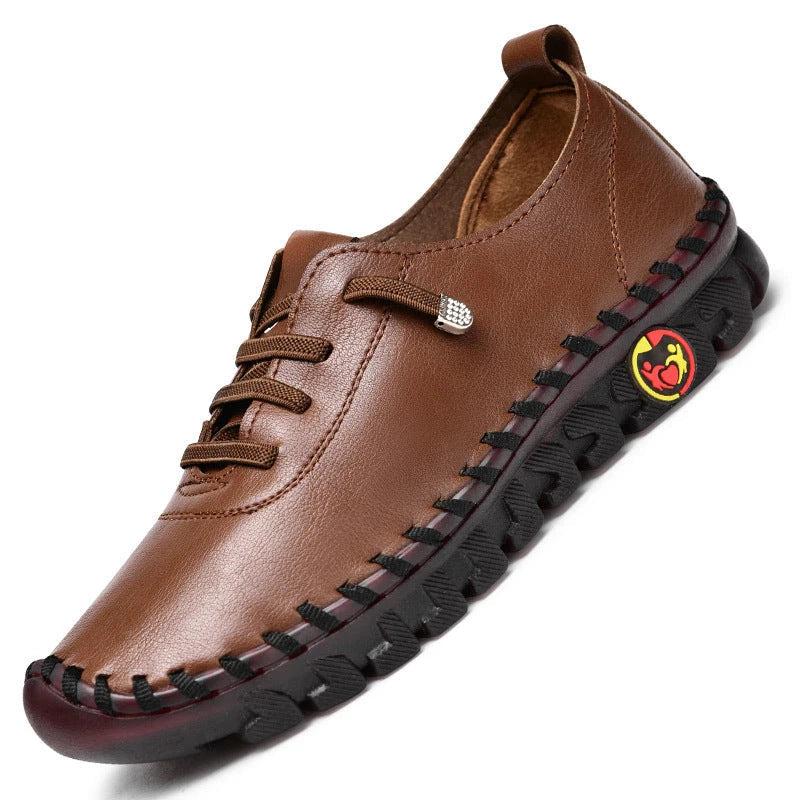 Brown leather shoe with black sole on a white background